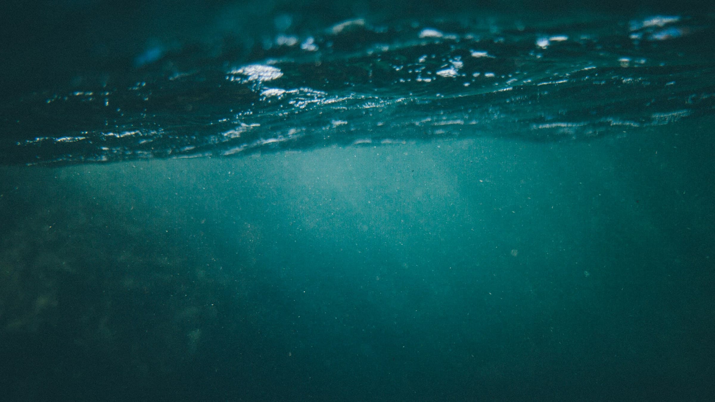 Light filtering through deep blue water